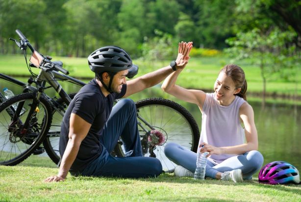 duas pessoas de bicicleta no parque